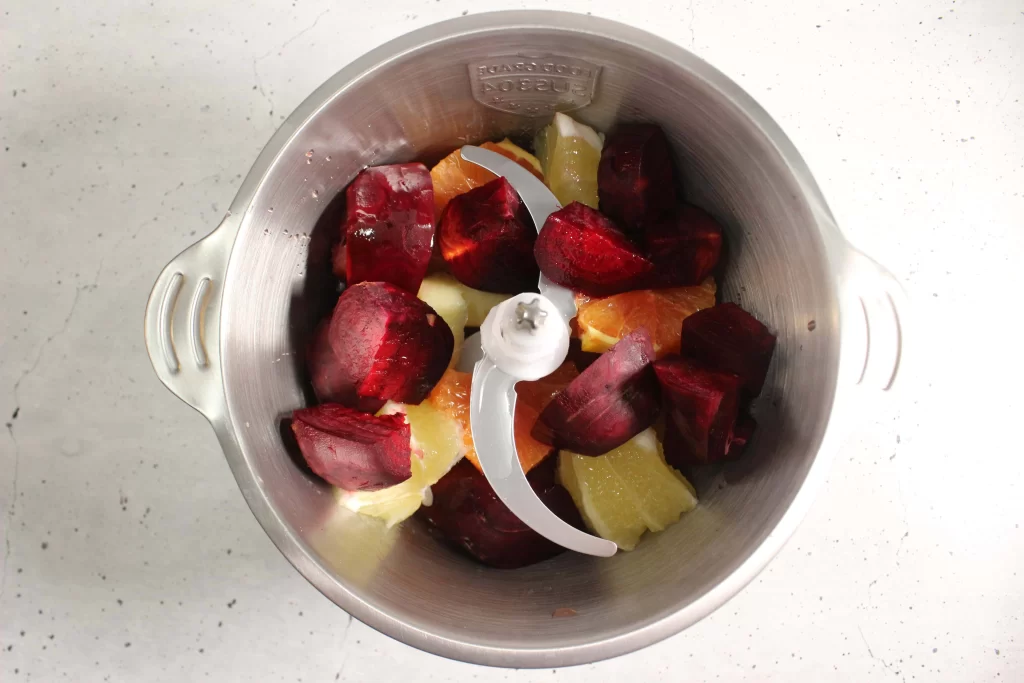 fruits in a stainless steel blender