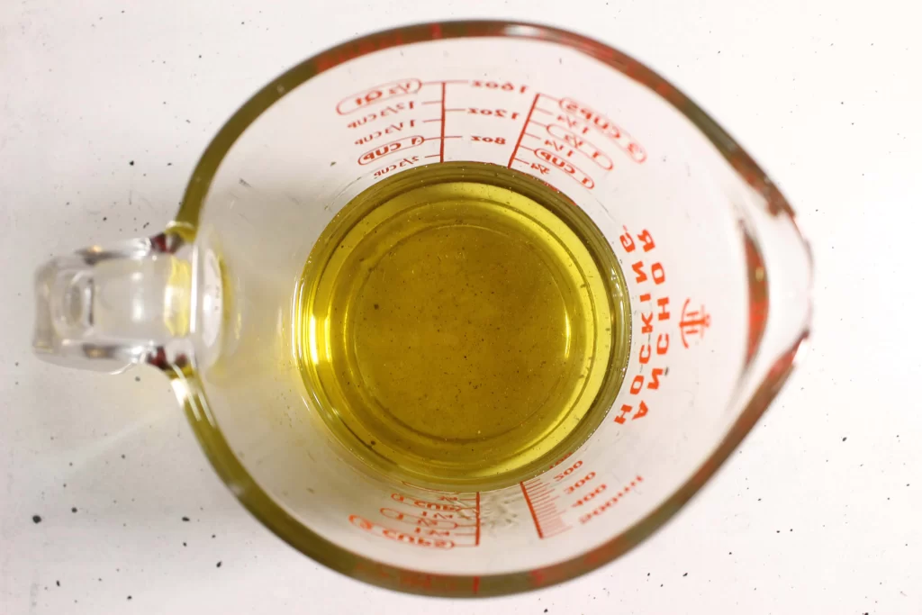 Melted oils and beeswax in a glass bowl